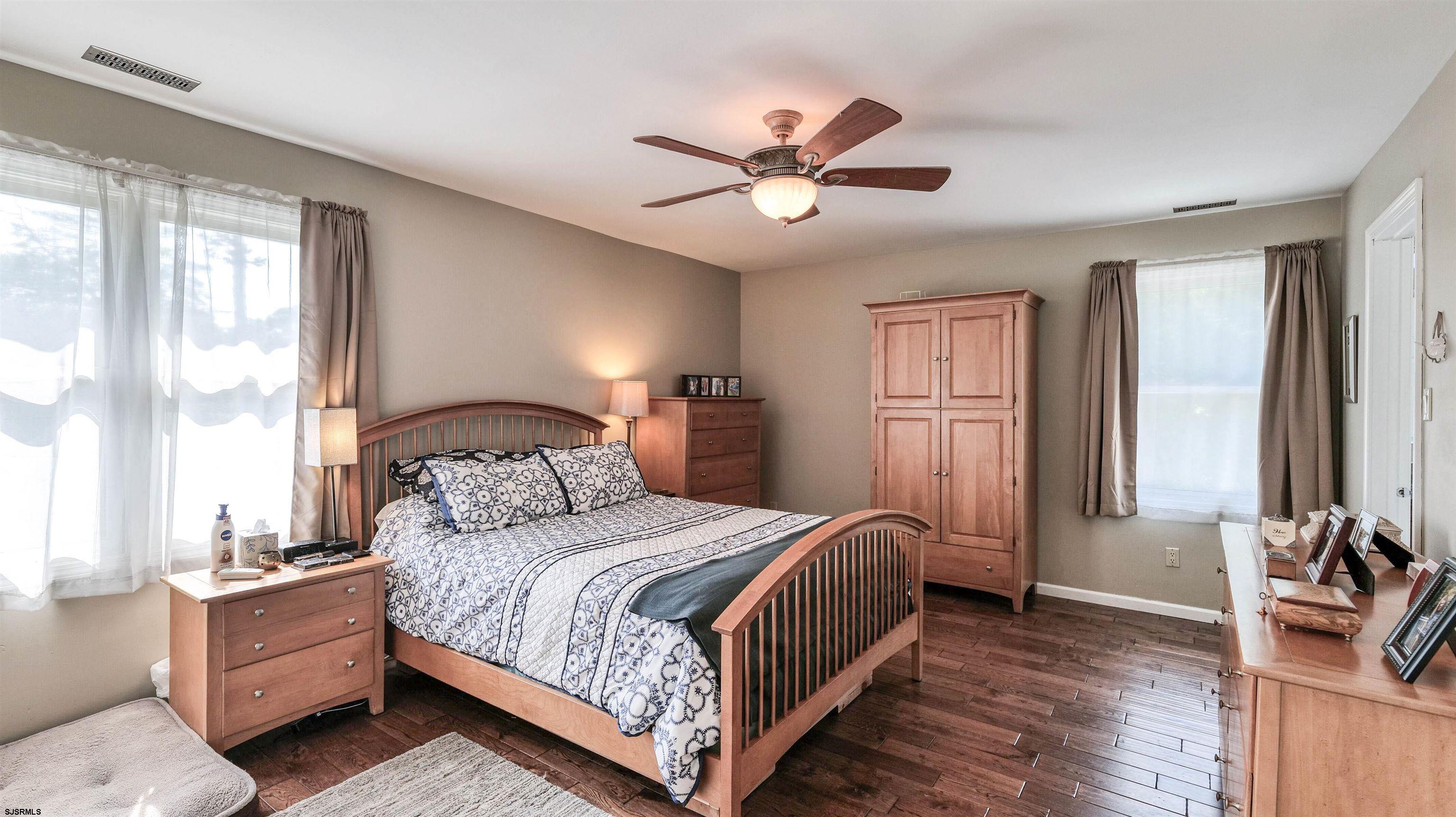 209 Reed Road Absecon, NJ 08201 - Photo 25 of 57 a bedroom with a bed and a chandelier