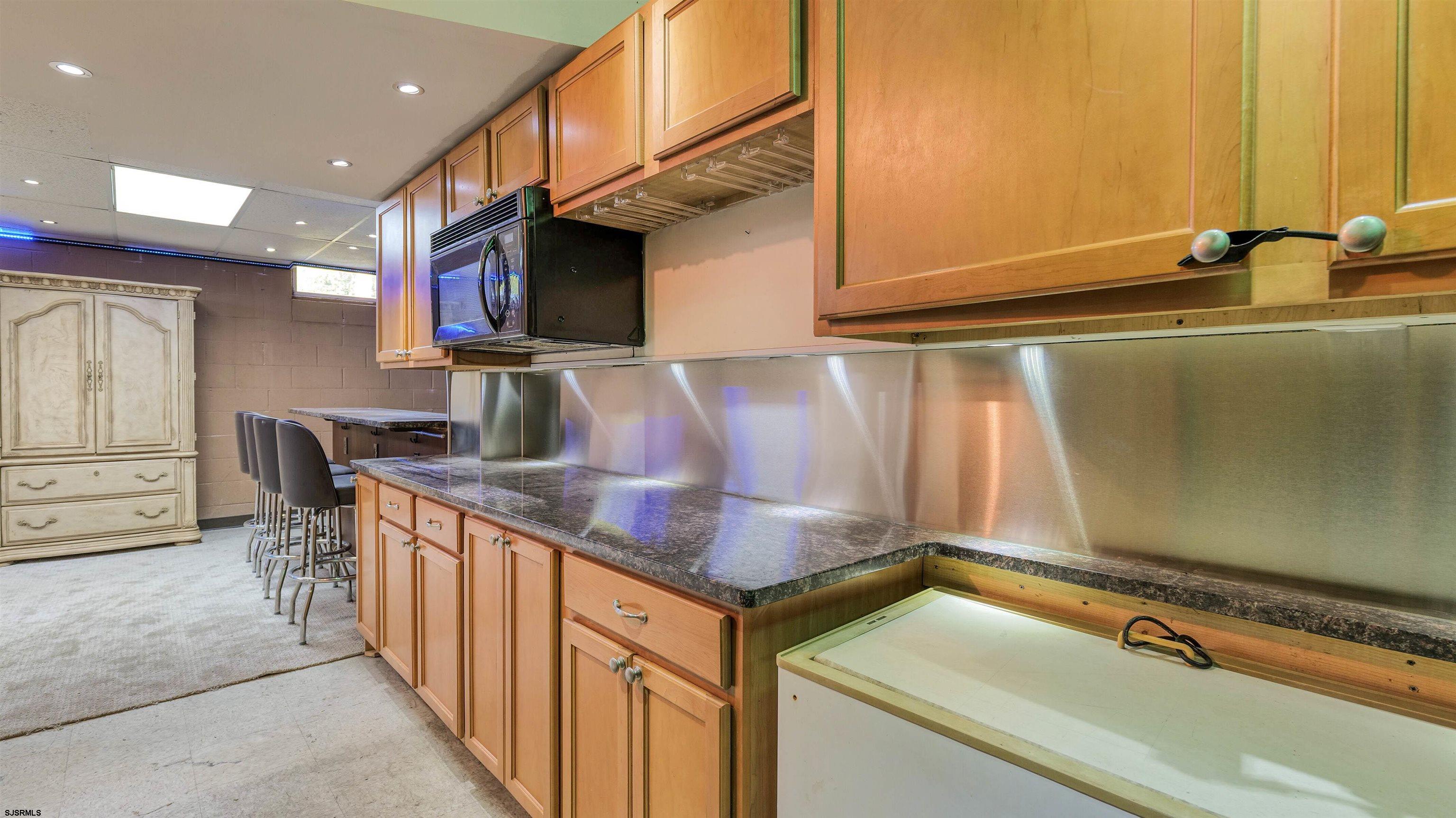 209 Reed Road Absecon, NJ 08201 - Photo 37 of 57 a kitchen with stainless steel appliances granite countertop a sink and a refrigerator