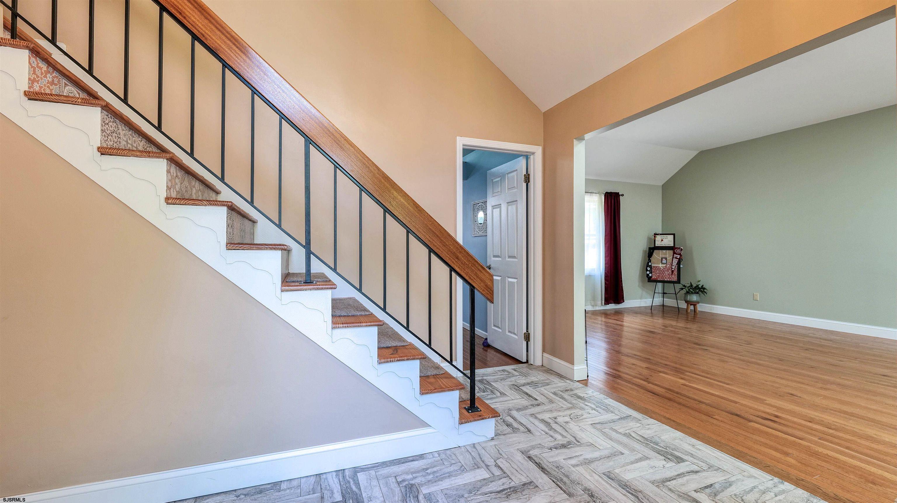 209 Reed Road Absecon, NJ 08201 - Photo 4 of 57 a view of staircase with wooden floor and a rug