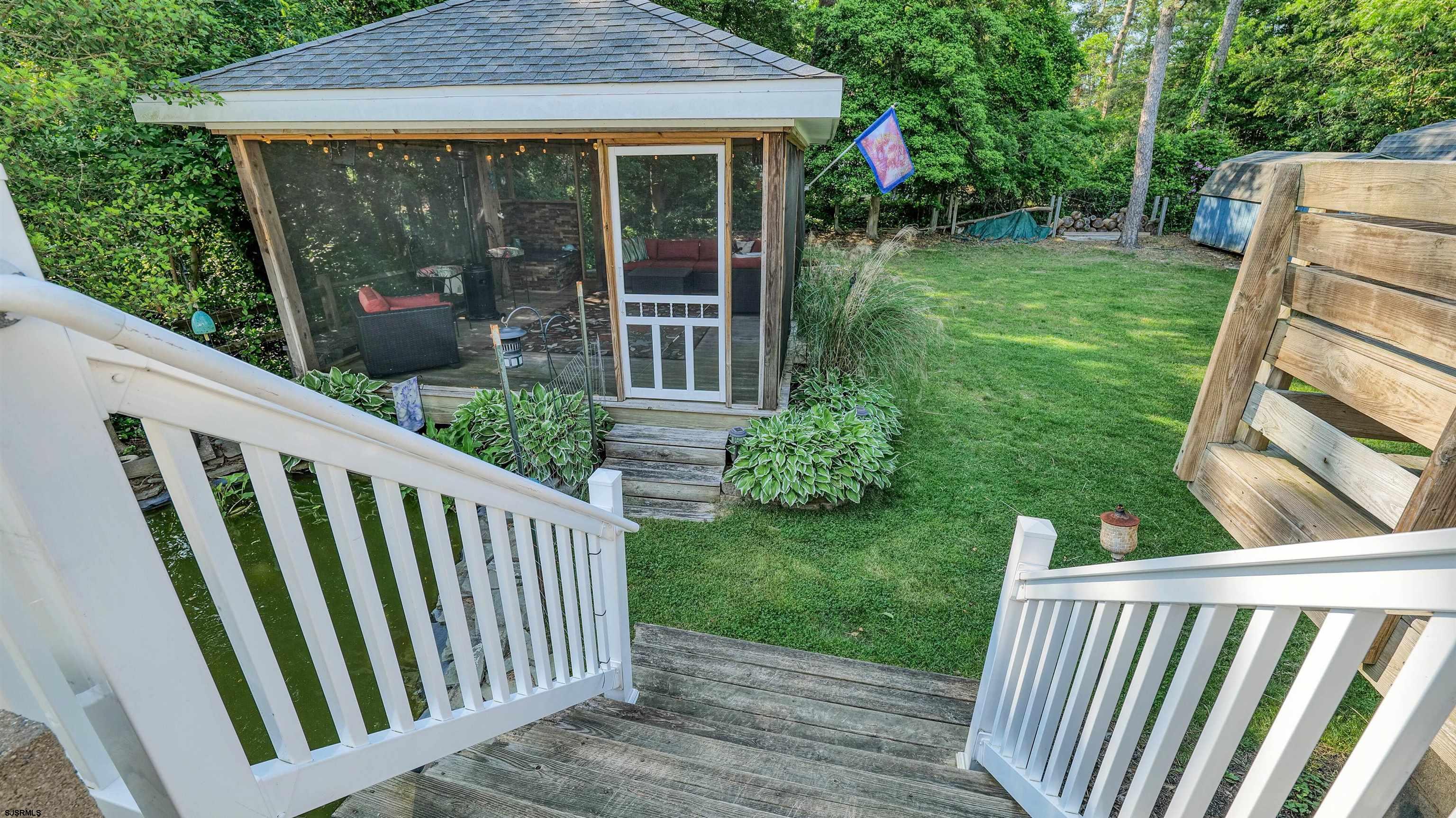 209 Reed Road Absecon, NJ 08201 - Photo 43 of 57 a view of backyard with green space and porch