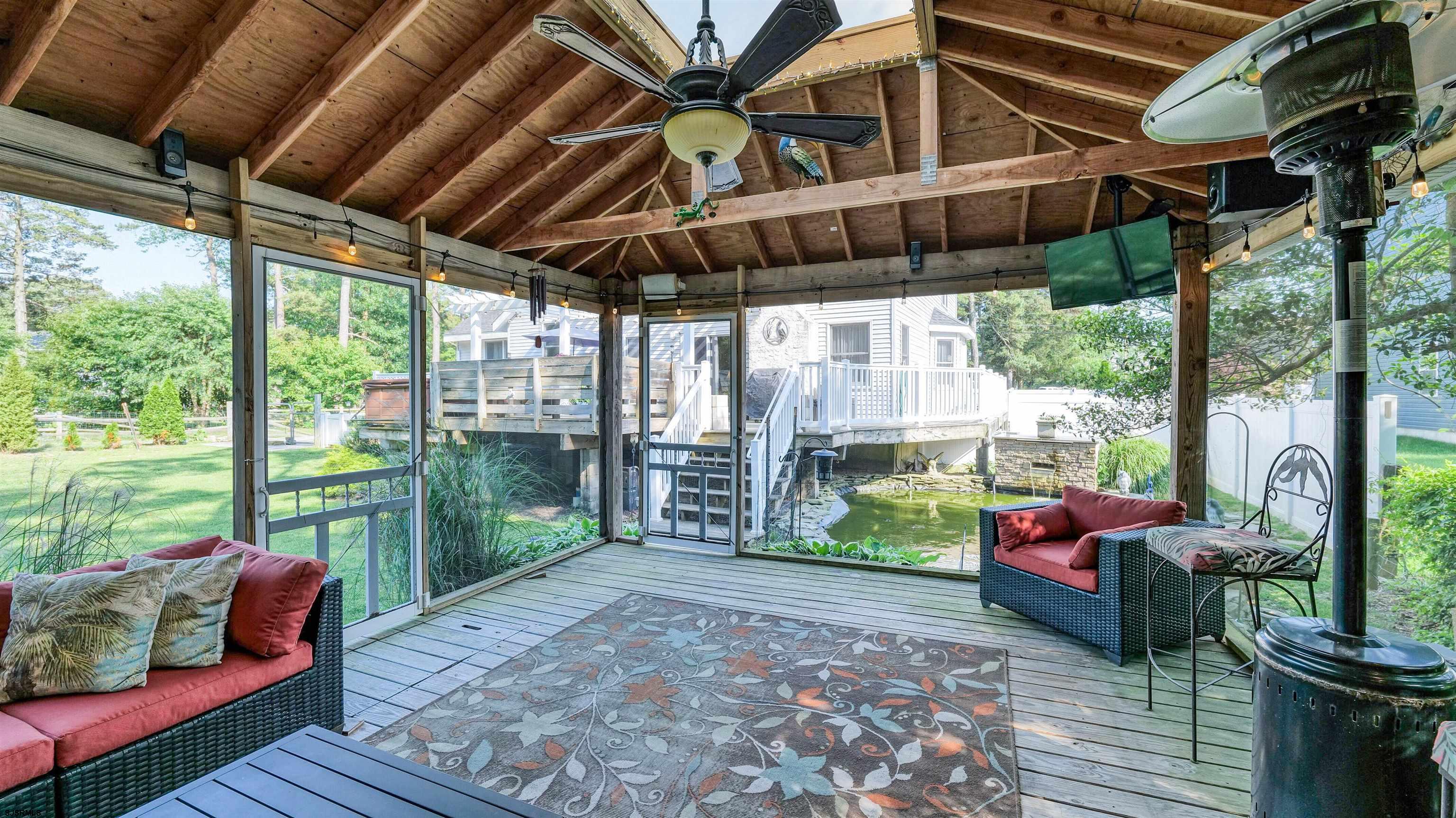 209 Reed Road Absecon, NJ 08201 - Photo 47 of 57 a backyard of a house with garden and outdoor seating