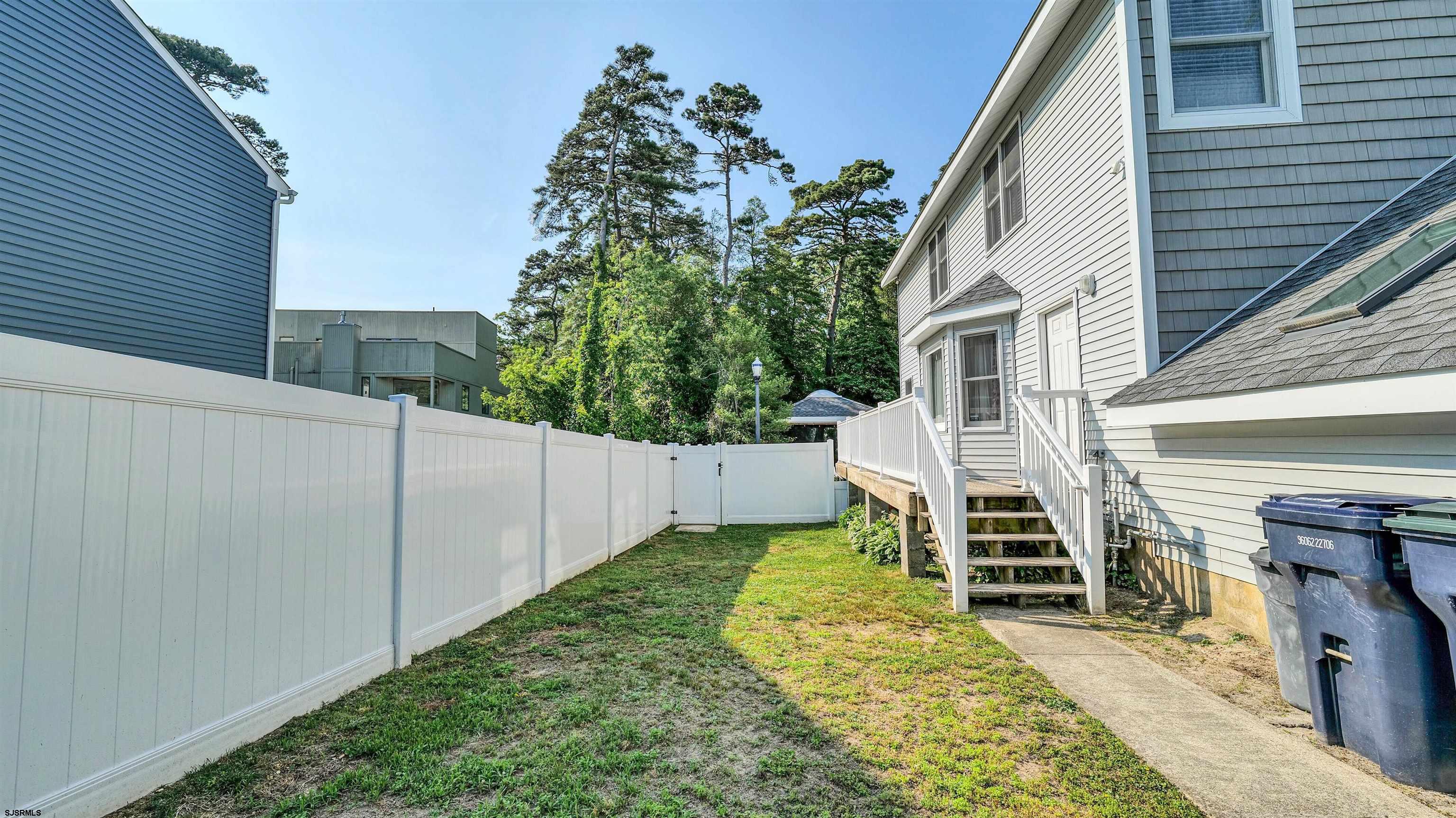 209 Reed Road Absecon, NJ 08201 - Photo 52 of 57 a view of a house with backyard and wooden fence