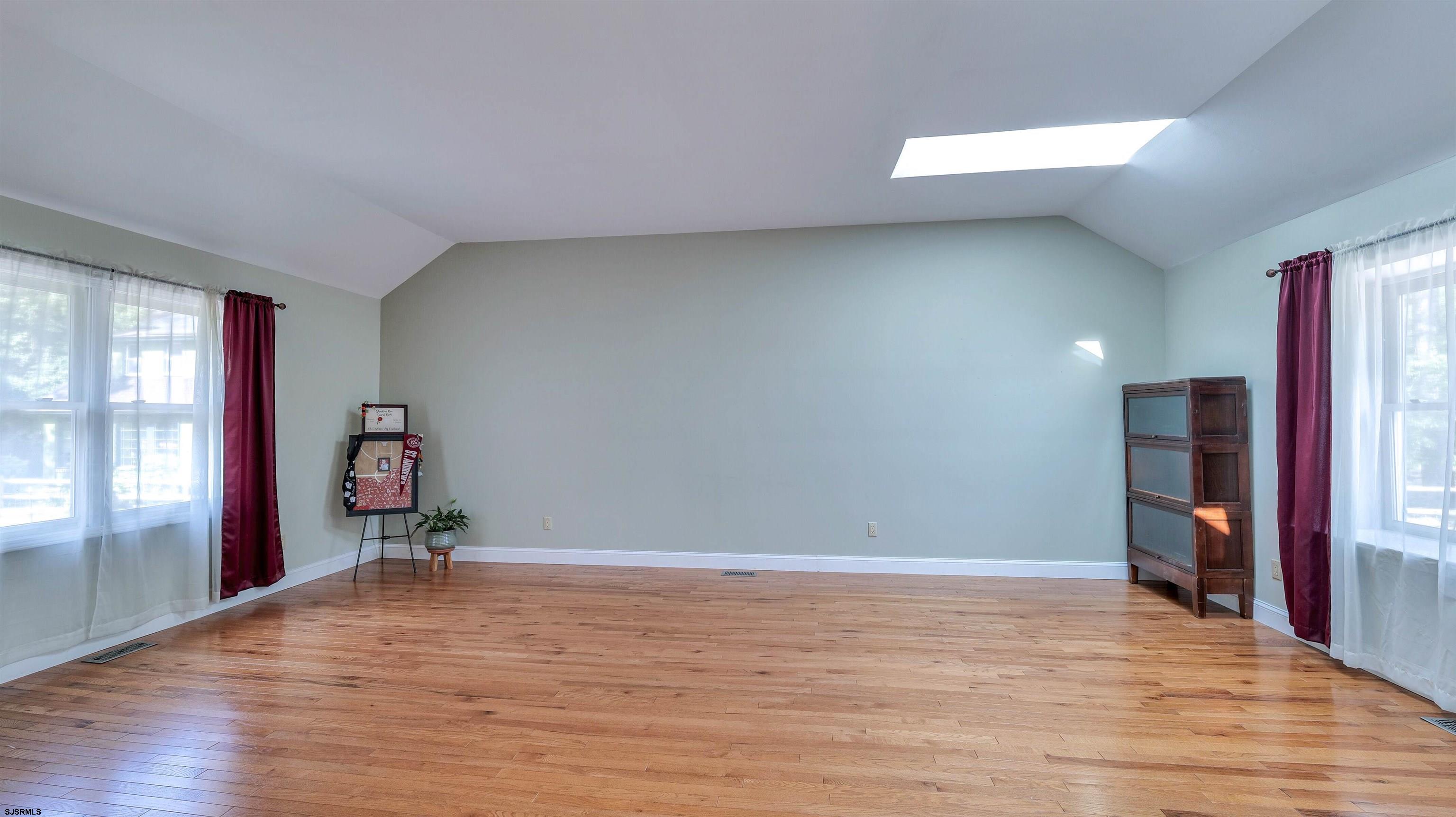 209 Reed Road Absecon, NJ 08201 - Photo 6 of 57 a view of empty room with wooden floor and fan