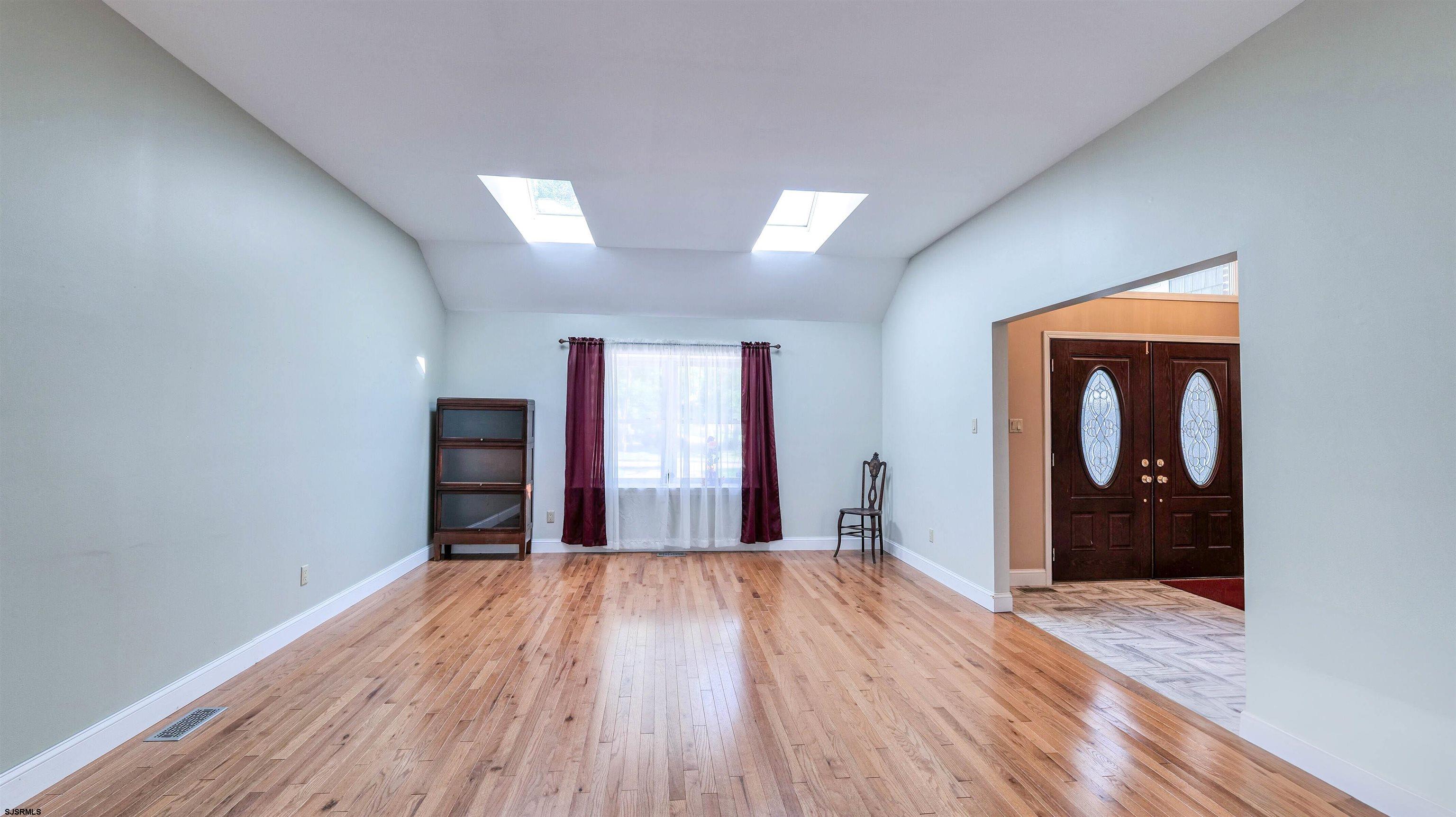 209 Reed Road Absecon, NJ 08201 - Photo 7 of 57 a view of empty room with wooden floor and fan