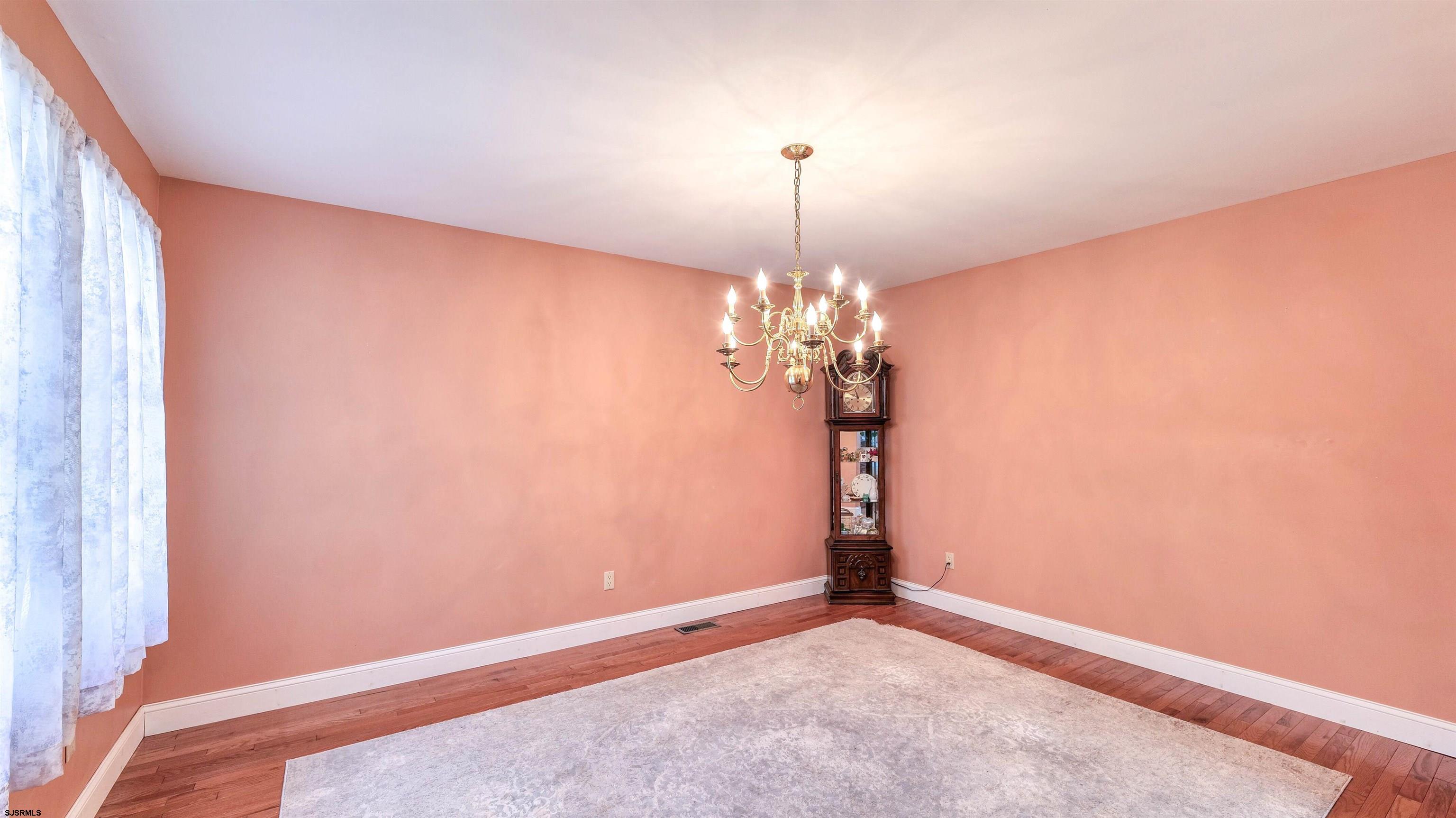 209 Reed Road Absecon, NJ 08201 - Photo 8 of 57 a view of a room with a chandelier fan and windows