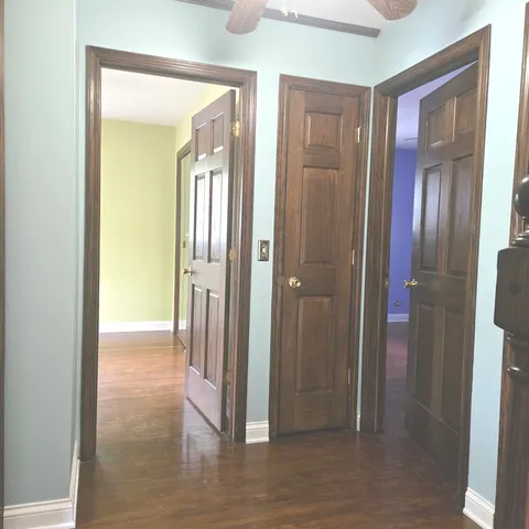 a living room with furniture a window and a flat screen tv