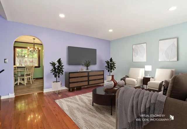 a view of a room with wooden floor and a ceiling fan