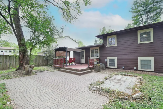 a backyard of a house with table and chairs