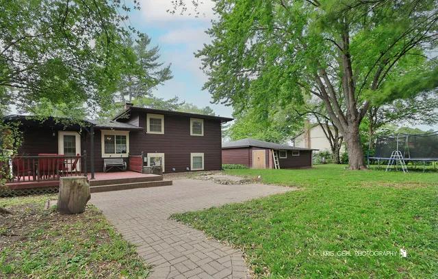 an aerial view of a house with a yard and lake view