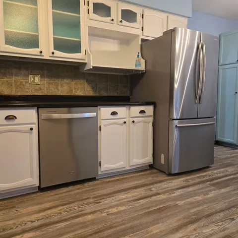 a kitchen with stainless steel appliances granite countertop a refrigerator and a stove