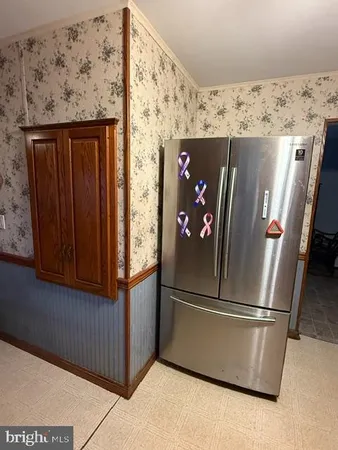 storage refrigerator freezer sitting inside of a kitchen