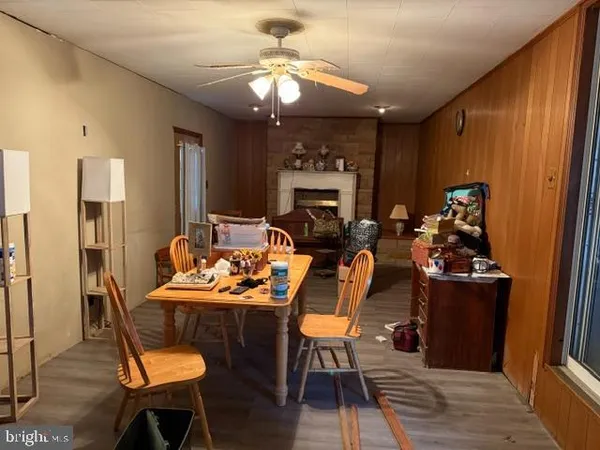 a view of a dining room with furniture a chandelier and wooden floor