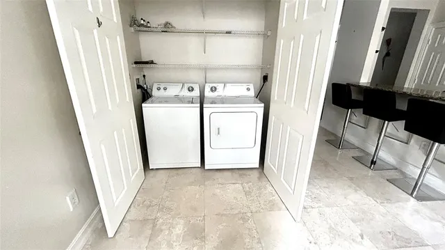 a view of a hallway with washer and dryer