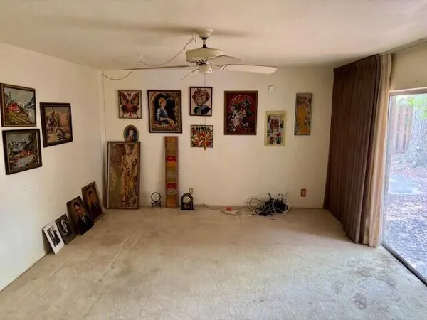 an empty room with windows and closet