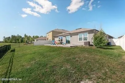 a front view of house with garden space and car parked