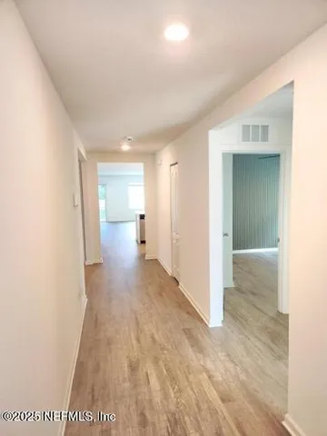 a kitchen with a sink cabinets and wooden floor