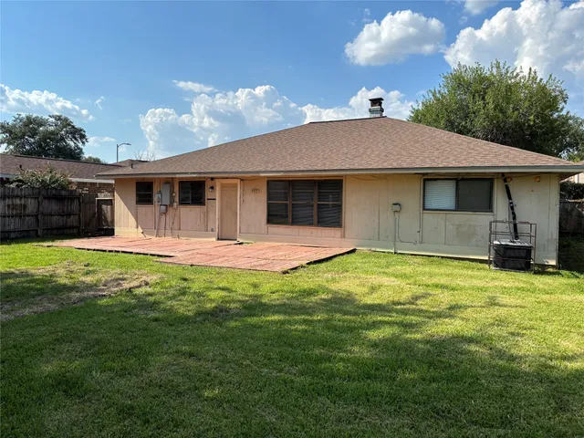 a backyard of a house with yard and outdoor seating