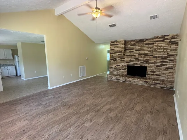 a view of an empty room with a fireplace