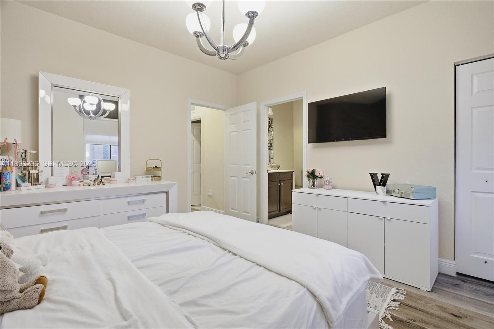 8870 Northwest 99th Path Doral, FL 33178 - Photo 16 of 44 a bedroom with a large bed and a flat screen tv