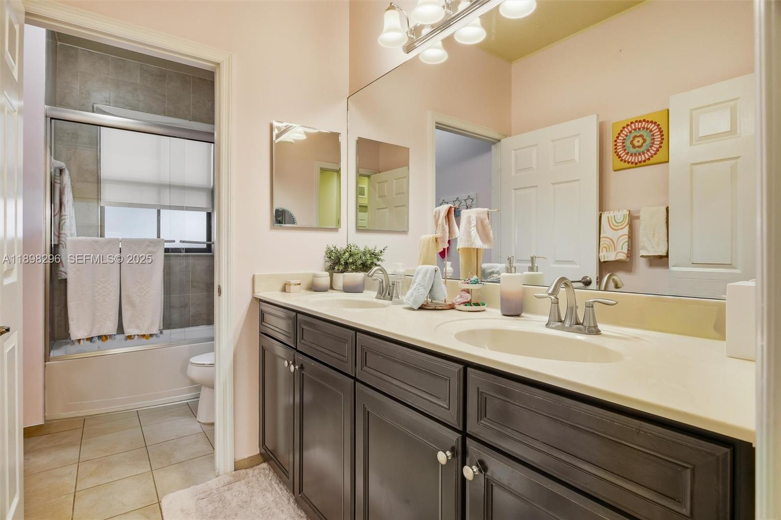 8870 Northwest 99th Path Doral, FL 33178 - Photo 20 of 44 a bathroom with a double vanity sink mirror and toilet
