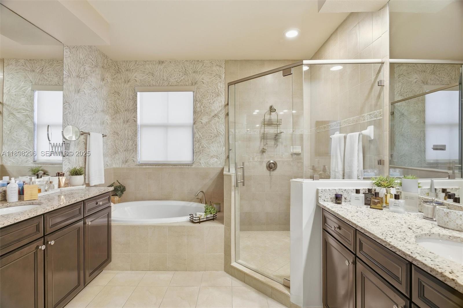 8870 Northwest 99th Path Doral, FL 33178 - Photo 23 of 44 a bathroom with a granite countertop sink mirror shower and bathtub