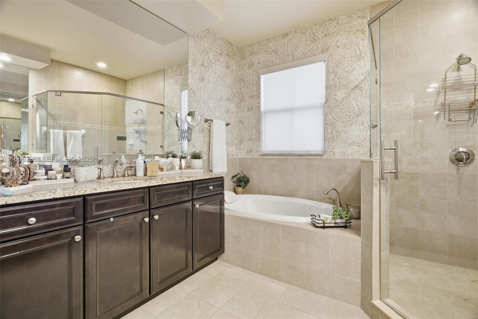 8870 Northwest 99th Path Doral, FL 33178 - Photo 24 of 44 a bathroom with a tub sink shower and mirror