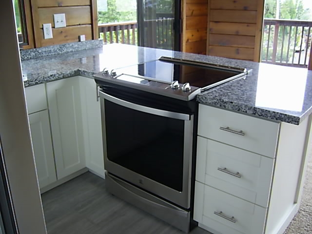 4615 Lower Kula Road Kula, HI 96790 - Photo 8 of 20 a kitchen with granite countertop white cabinets and stainless steel appliances