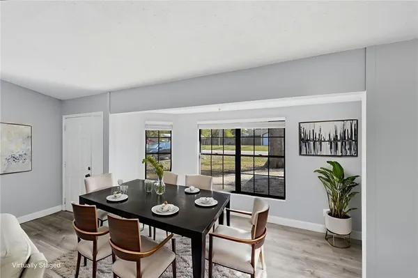 a view of a dining room with furniture and window