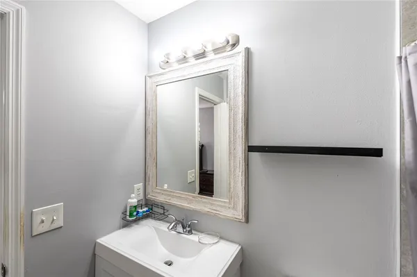 a bathroom with a sink and mirror