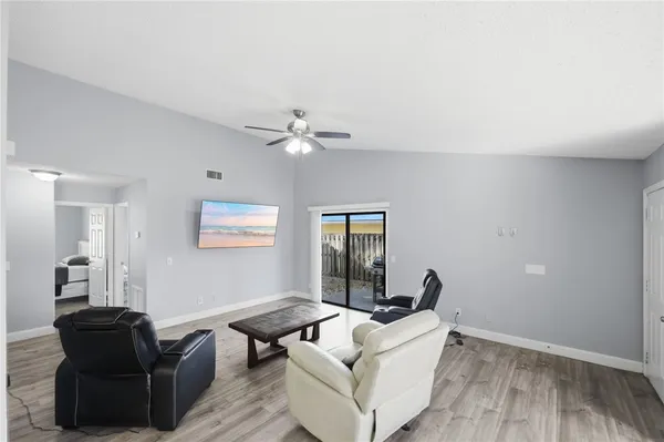 a living room with furniture and wooden floor