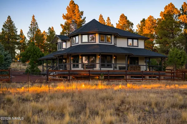 a kitchen with stainless steel appliances granite countertop a refrigerator a sink a stove and a wooden floors