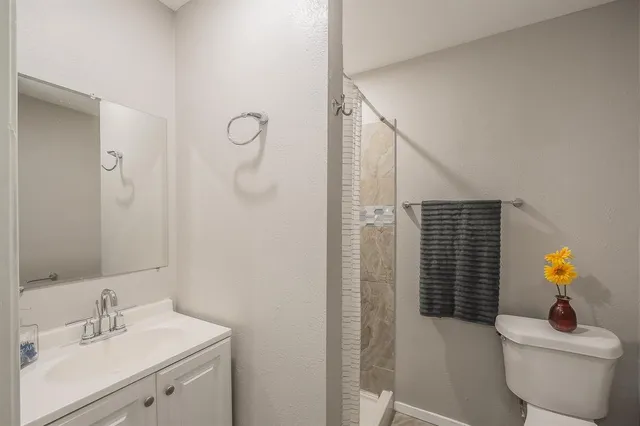 a bathroom with a sink toilet and shower
