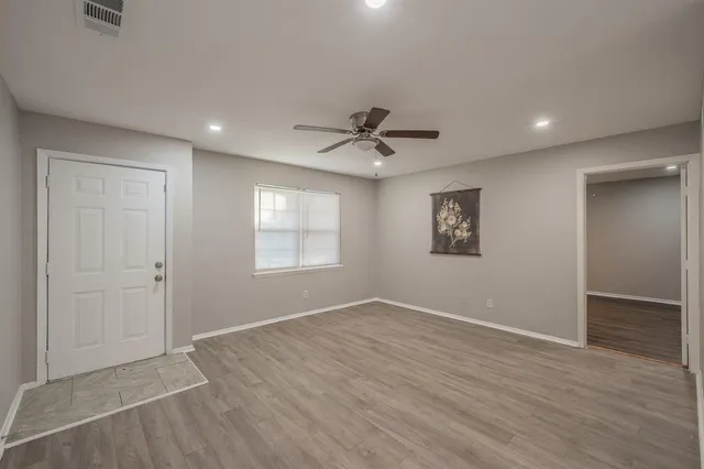 wooden floor in an empty room with a window
