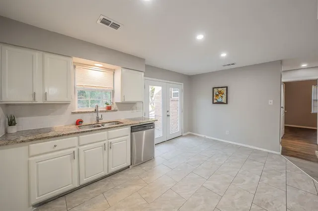 a kitchen with a sink and cabinets