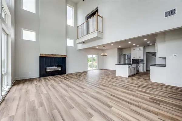 a view of a kitchen with wooden floor and kitchen view