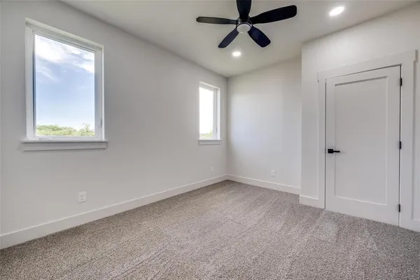 a view of a room with wooden floor and white walls