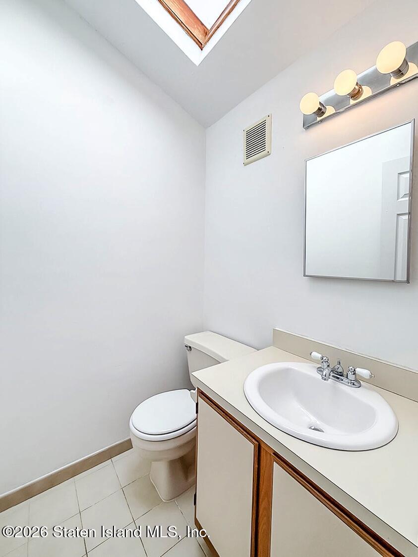3438 A Amboy Road Staten Island, NY 10306 - Photo 11 of 21 a bathroom with a sink a toilet and mirror