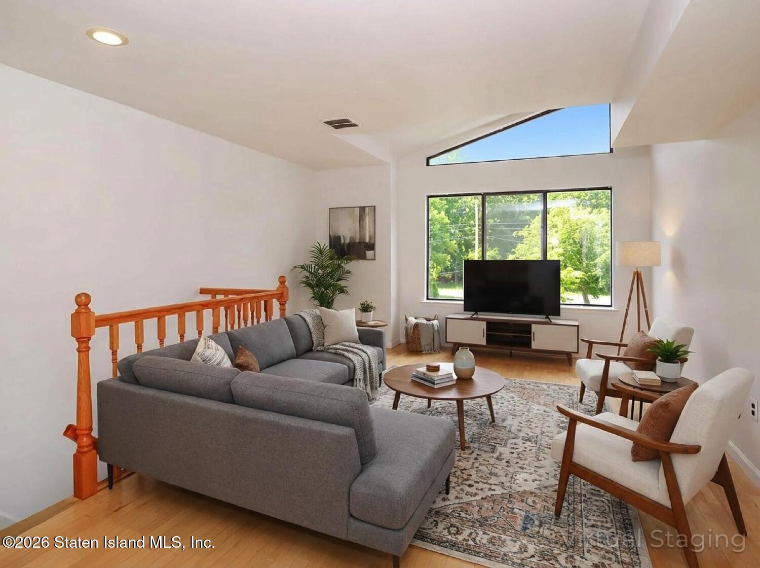 3438 A Amboy Road Staten Island, NY 10306 - Photo 5 of 21 a living room with furniture a flat screen tv and a large window