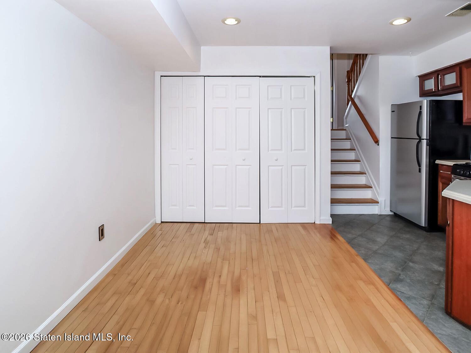 3438 A Amboy Road Staten Island, NY 10306 - Photo 7 of 21 a view of a room with stairs and wooden floor