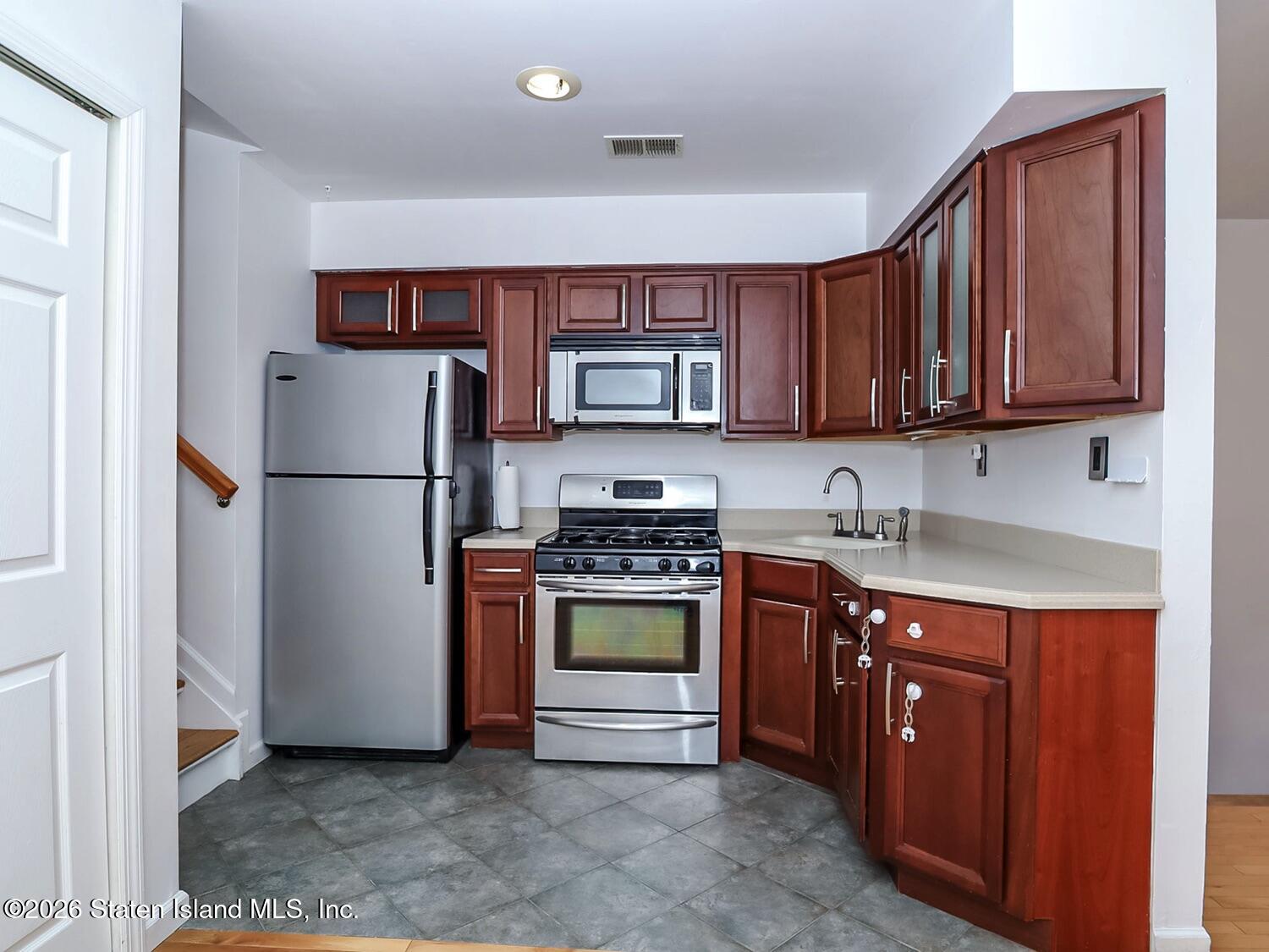 3438 A Amboy Road Staten Island, NY 10306 - Photo 9 of 21 a kitchen with stainless steel appliances granite countertop a refrigerator and a stove