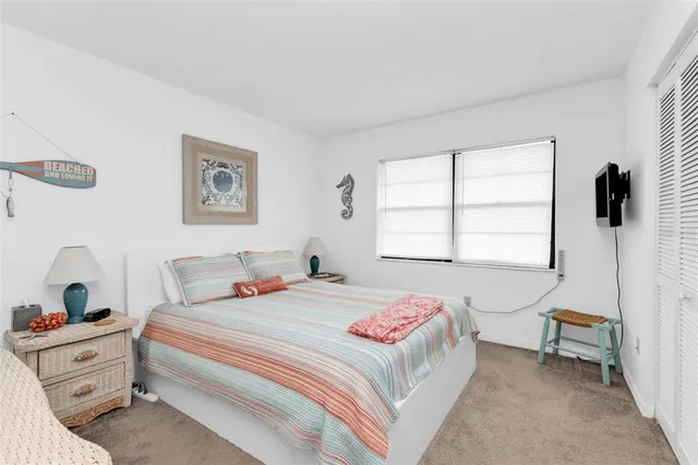 a spacious bedroom with a bed and a dresser