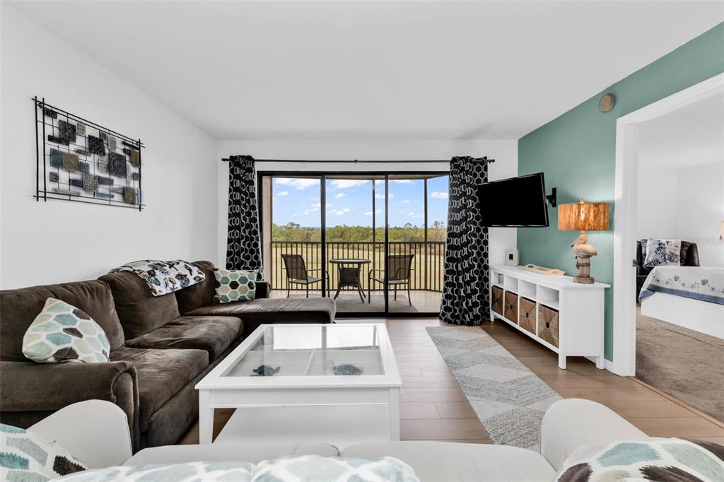 175 Kings Highway, Unit 723 Punta Gorda, FL 33983 - Photo 6 of 30 a living room with furniture and a flat screen tv