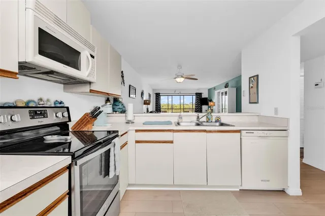 a kitchen with cabinets and stainless steel appliances