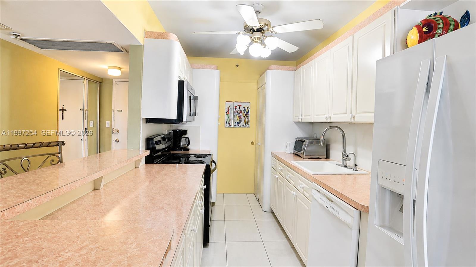 100 Lincoln Road, Unit 422 Miami Beach, FL 33139 - Photo 4 of 23 a kitchen with stainless steel appliances a stove a sink and a refrigerator