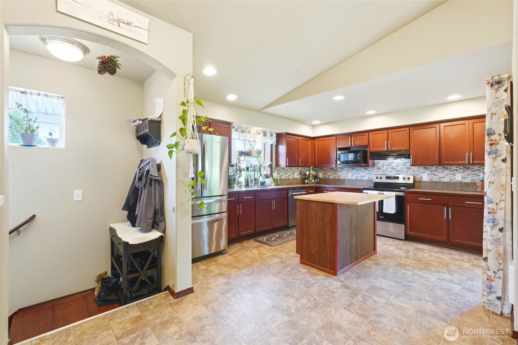 310 Jeff Street Mount Vernon, WA 98274 - Photo 11 of 35 a kitchen with stainless steel appliances kitchen island granite countertop a refrigerator and a sink