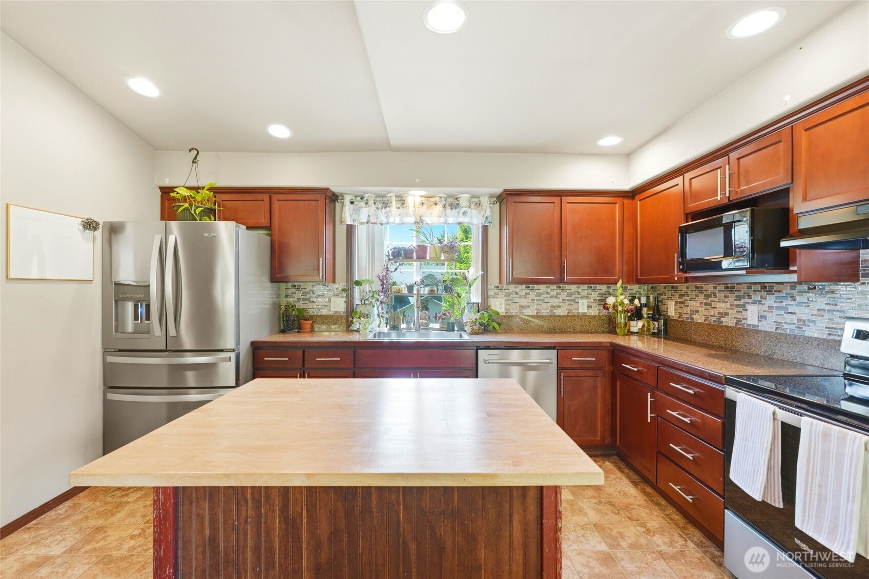 310 Jeff Street Mount Vernon, WA 98274 - Photo 18 of 35 a kitchen with stainless steel appliances granite countertop a refrigerator a sink dishwasher a stove with wooden cabinets and a granite counter top