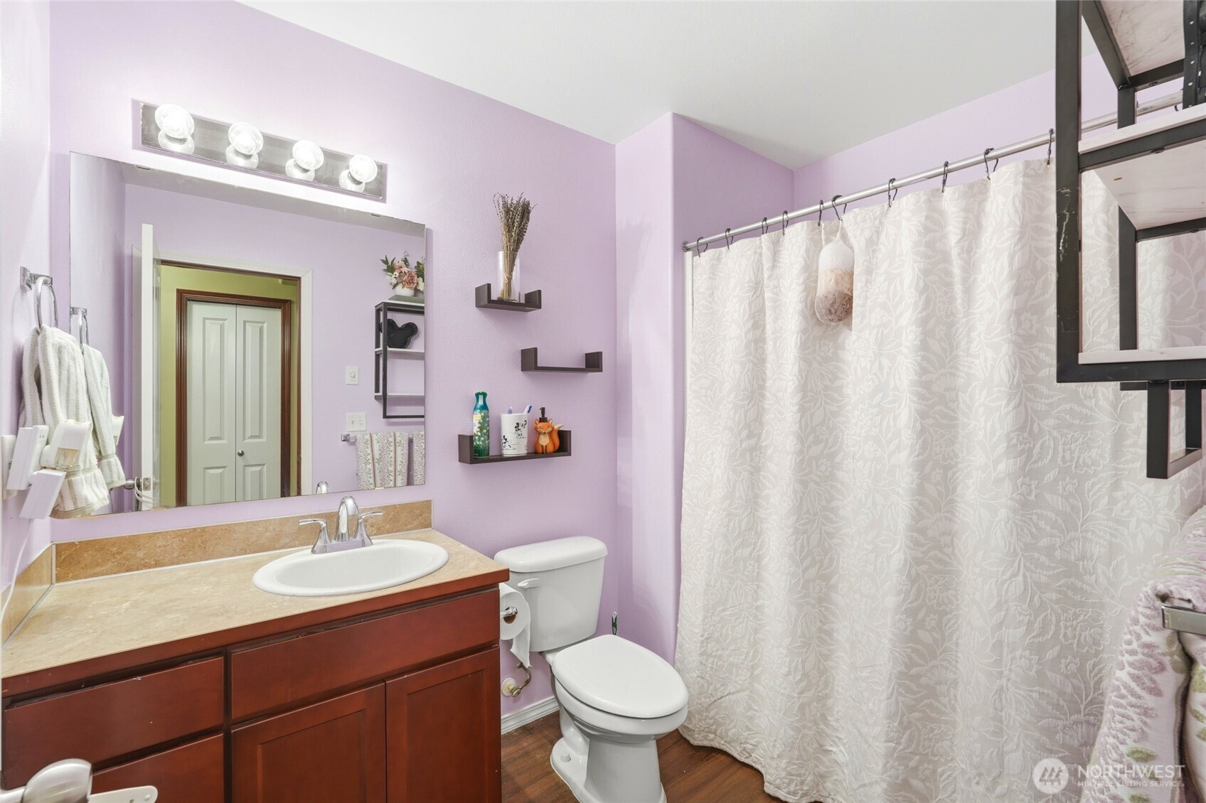 310 Jeff Street Mount Vernon, WA 98274 - Photo 24 of 35 a bathroom with a sink a toilet a mirror and shower curtain
