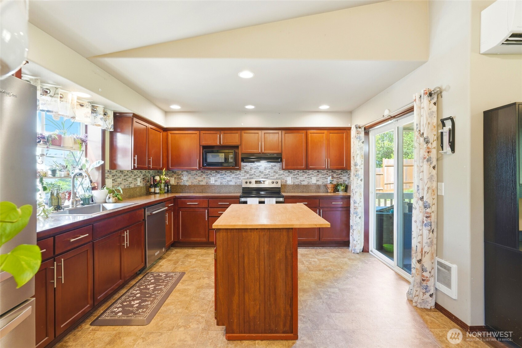 310 Jeff Street Mount Vernon, WA 98274 - Photo 4 of 35 a large kitchen with stainless steel appliances granite countertop a large stove a sink dishwasher and a refrigerator with wooden cabinets