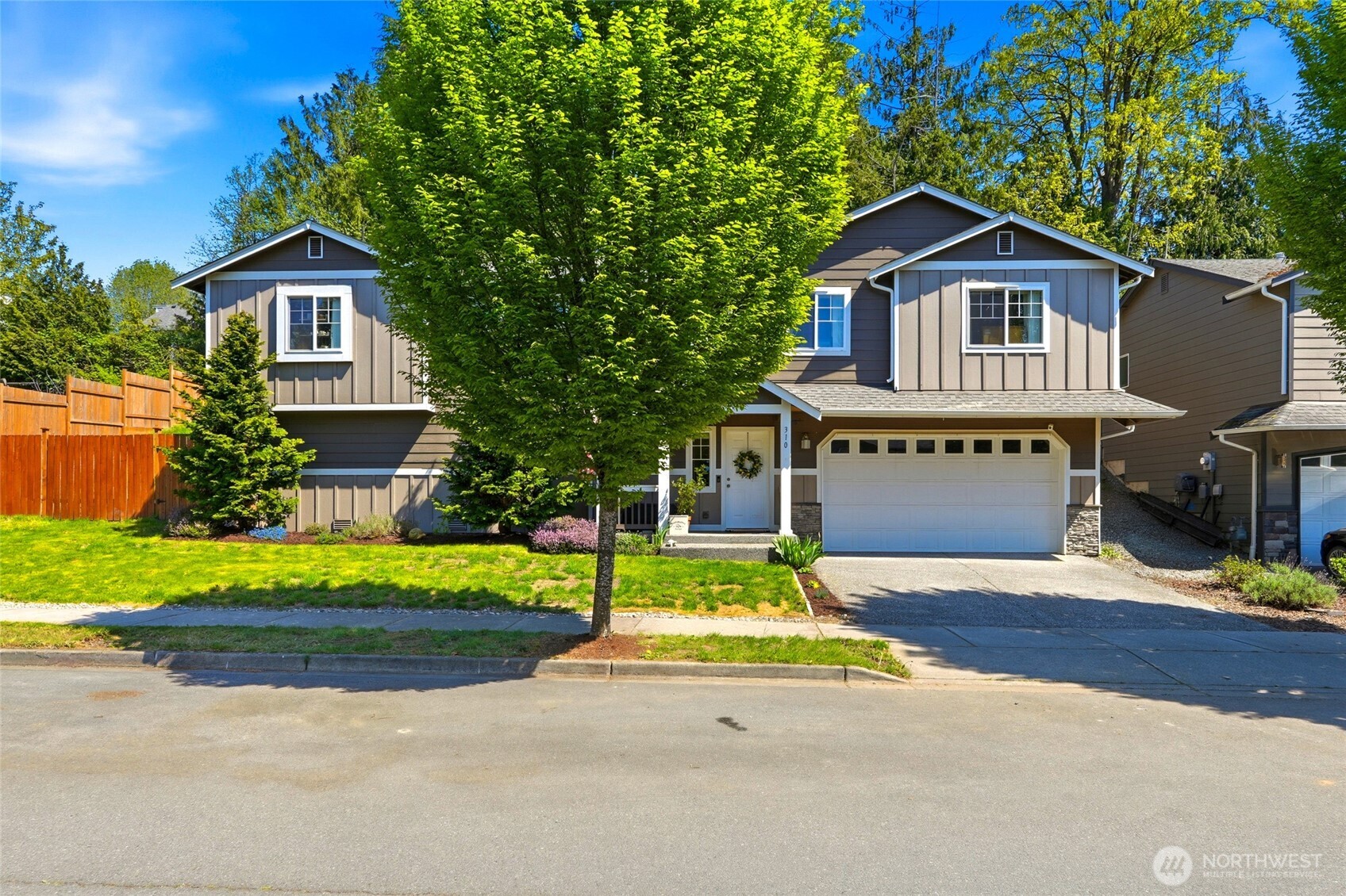 310 Jeff Street Mount Vernon, WA 98274 - Photo 7 of 35 a front view of a house with a yard and garage