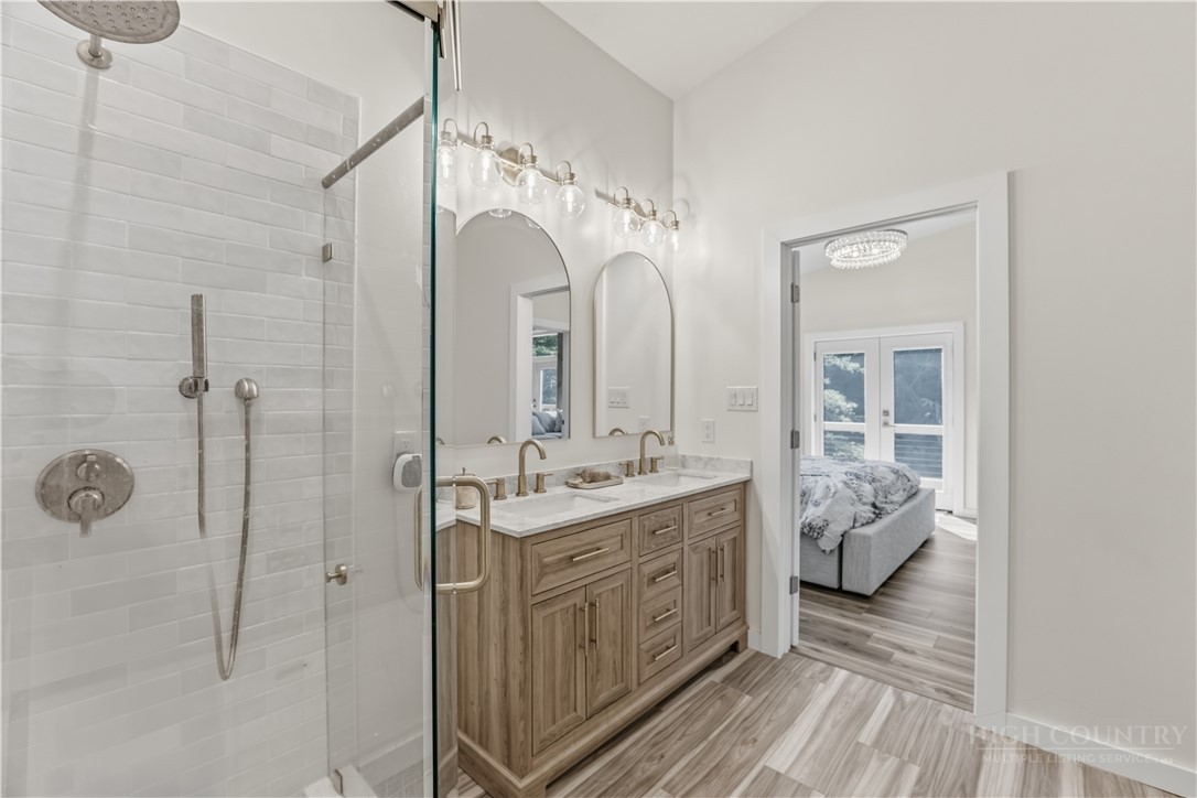 355 South River Hills Road Lansing, NC 28643 - Photo 6 of 45 a bathroom with a double vanity sink mirror and shower
